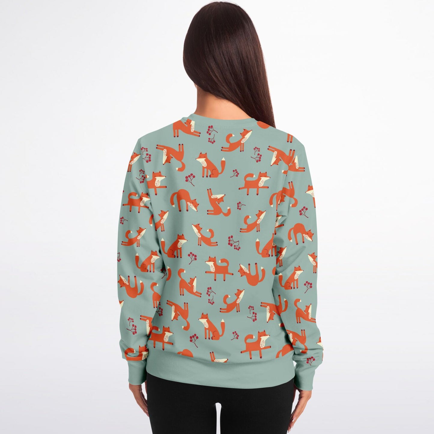 A woman wearing a lichen green unisex sweatshirt with Playful Fox -pattern, back view.