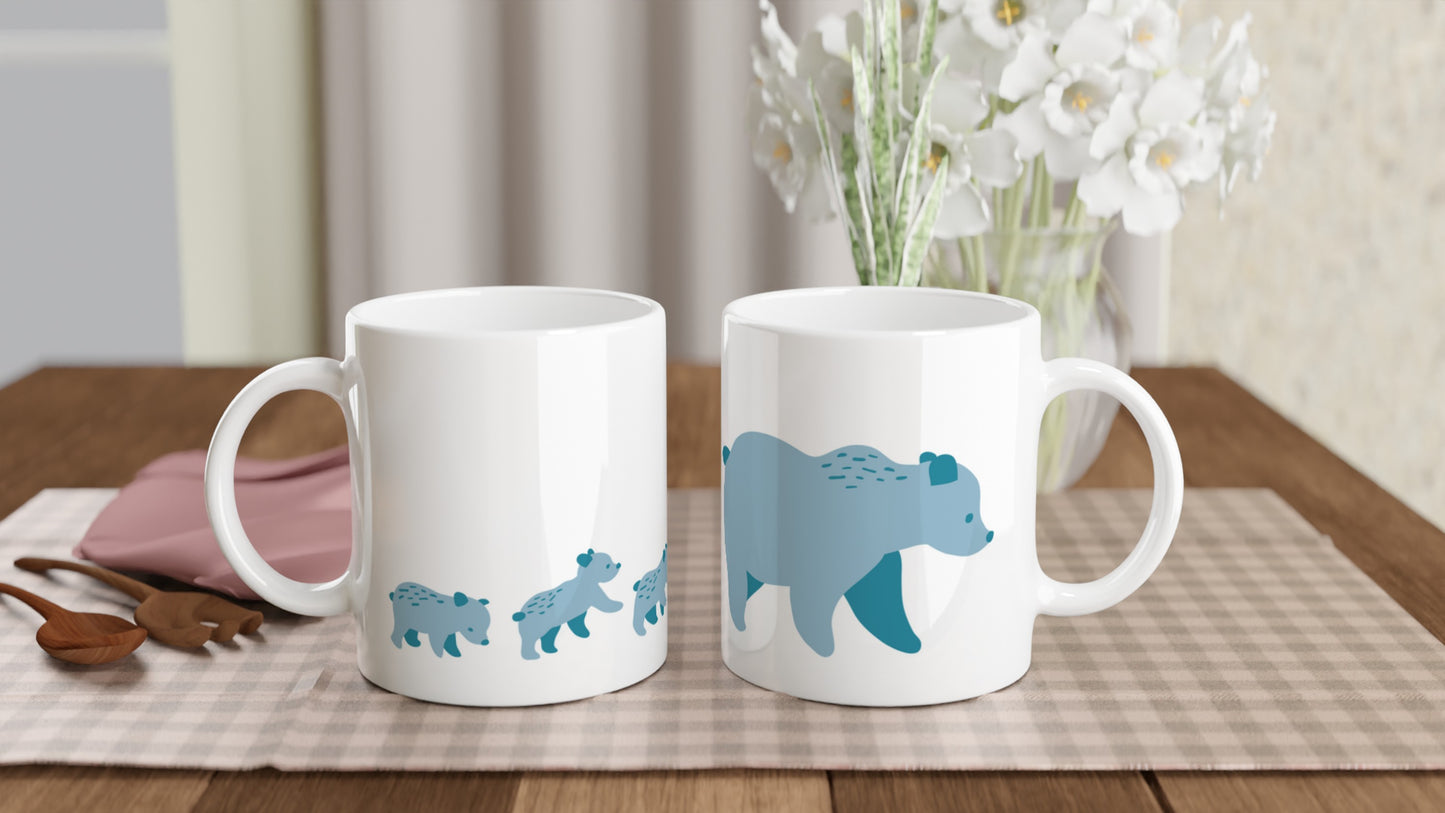 White ceramic mugs with a blue bear family print.