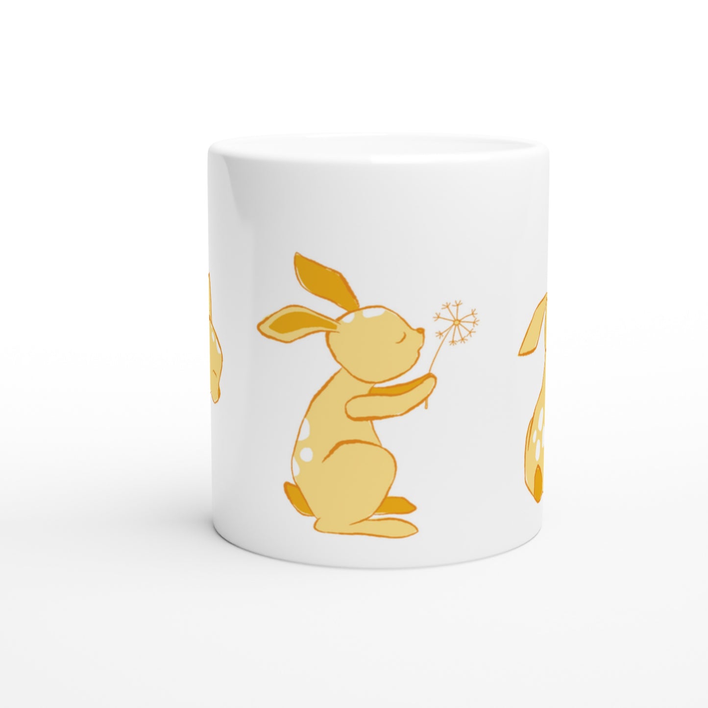 White ceramic mug with a yellow Dandelion and hare print.