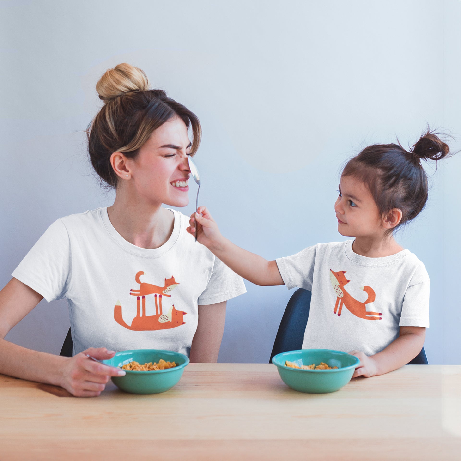 Mom and child being silly wearing Playful Fox -T-shirts.