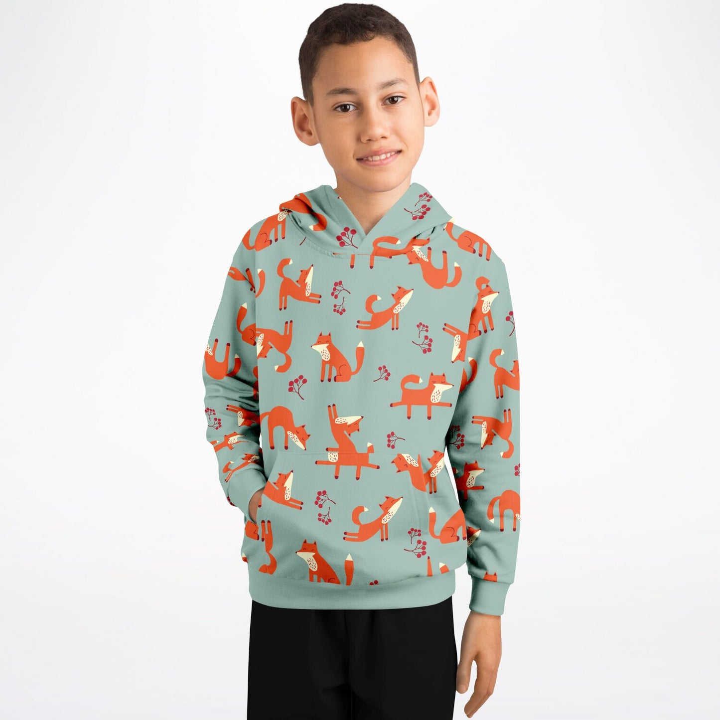 A boy wearing a lichen green hoodie with playful fox pattern.