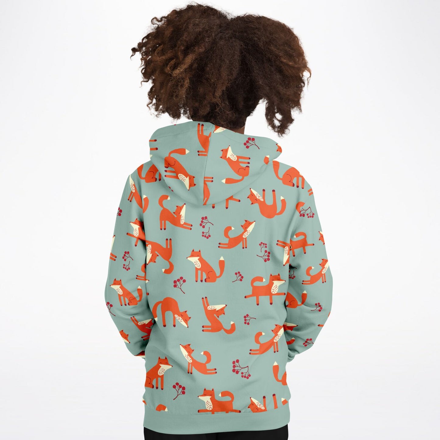 A girl wearing a lichen green hoodie with playful fox pattern.