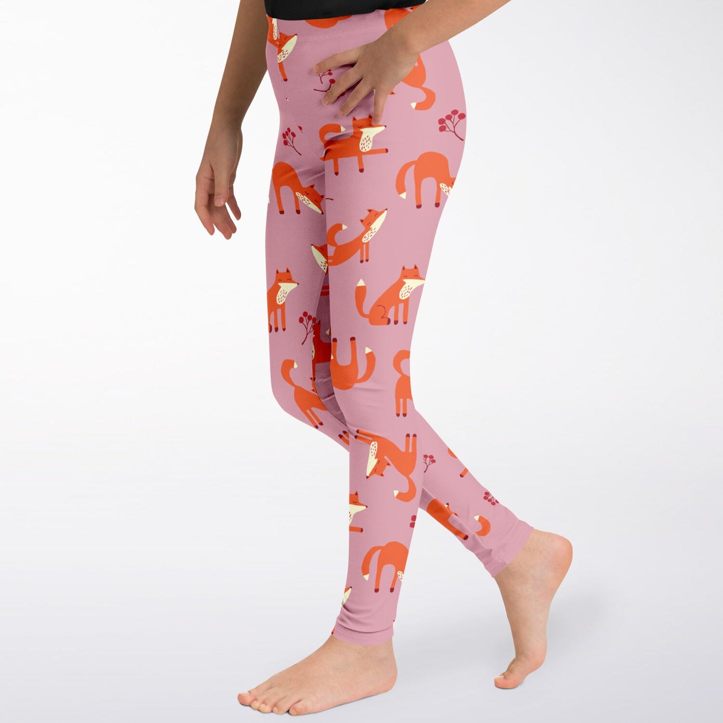 A girl wearing pink leggings with Playful Fox pattern, closeup.