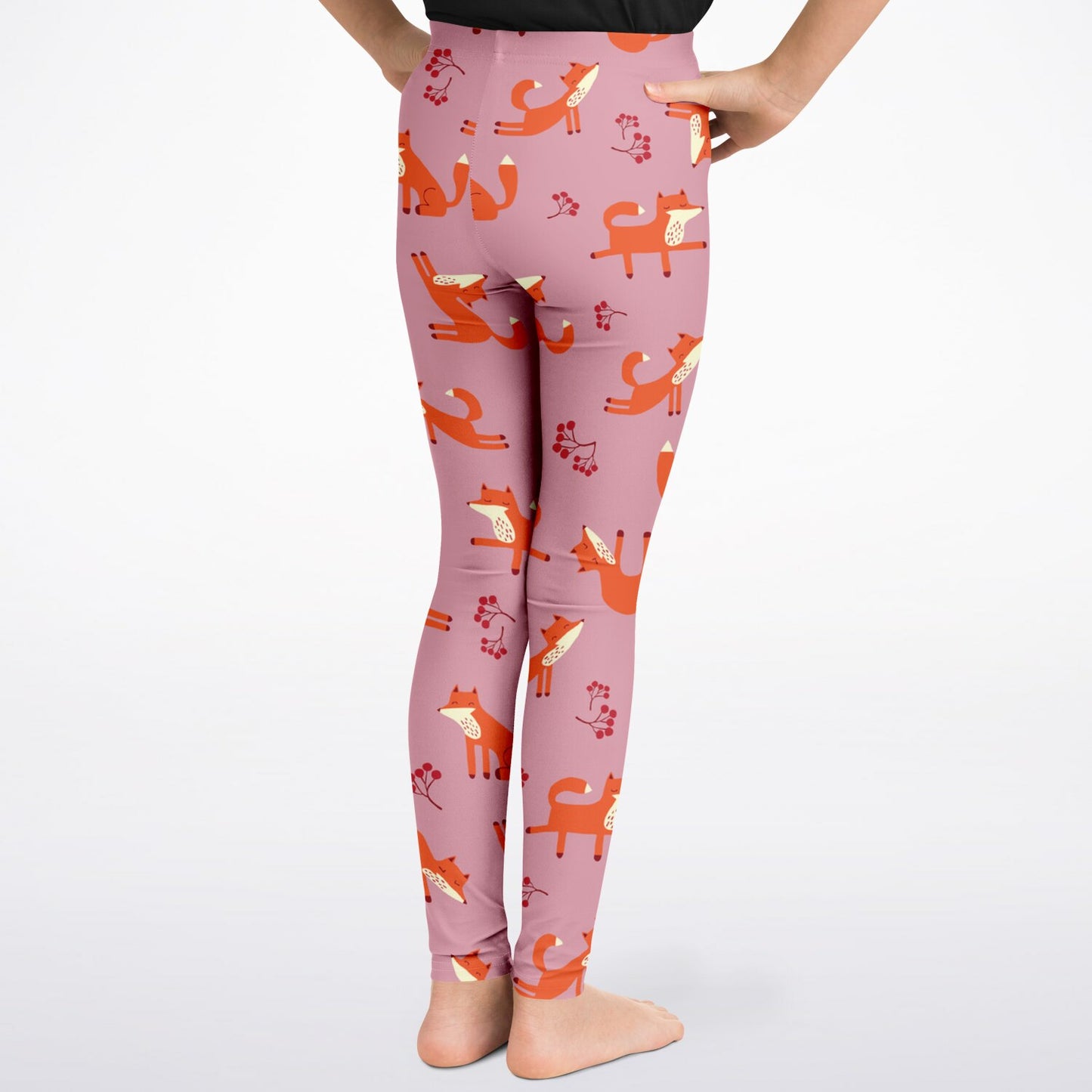 A girl wearing pink leggings with Playful Fox pattern, closeup.
