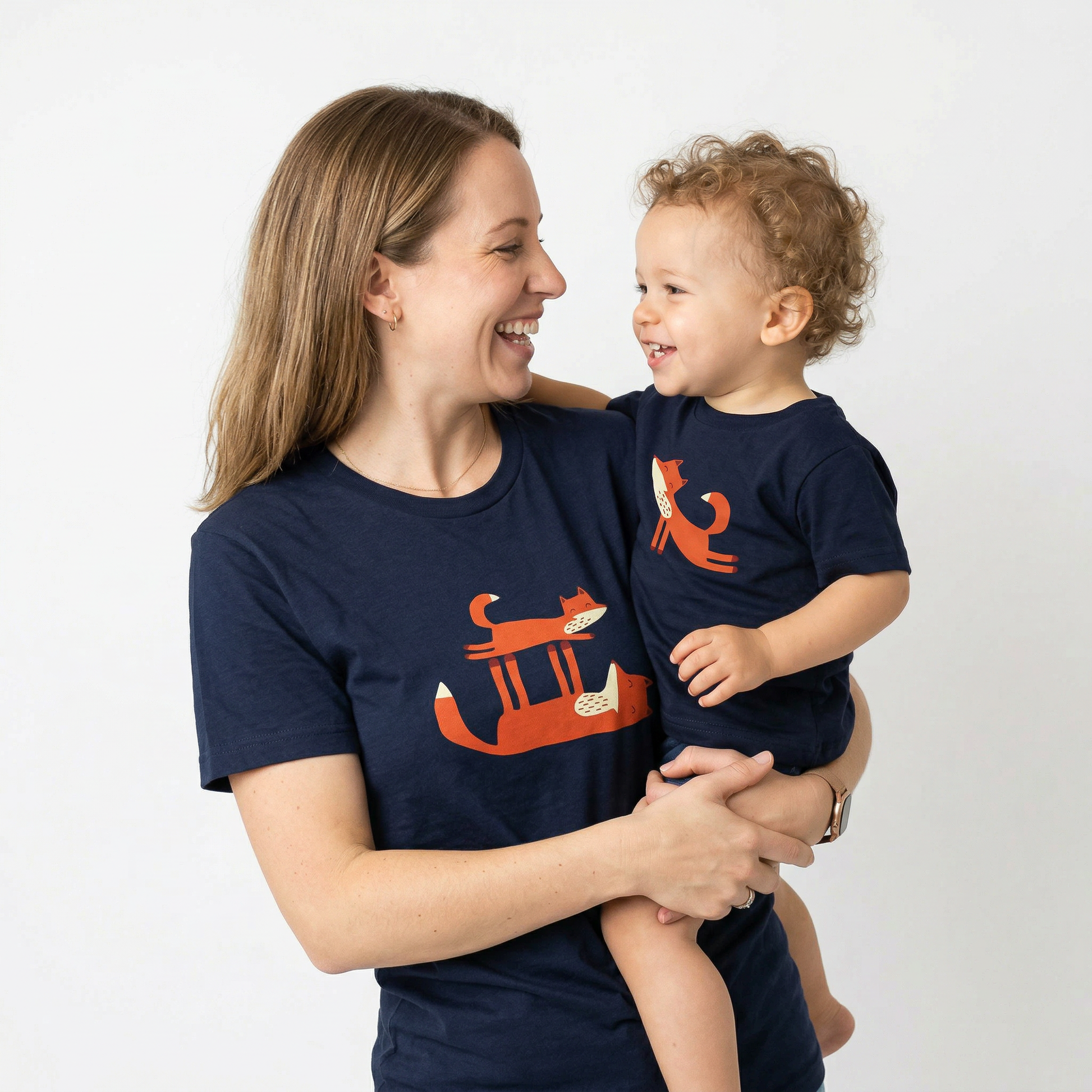 Mother and toddler wearing matching navy blue Playful Fox -print T-shirts