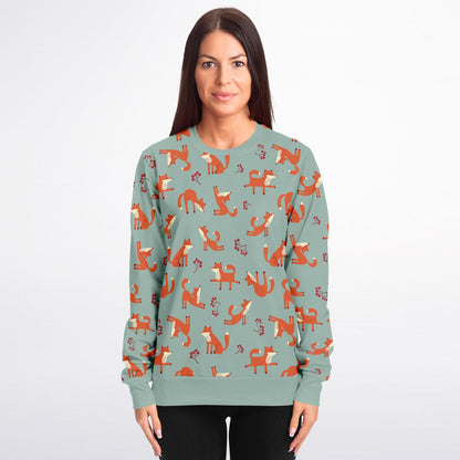 A woman wearing a lichen green unisex sweatshirt with Playful Fox -pattern.