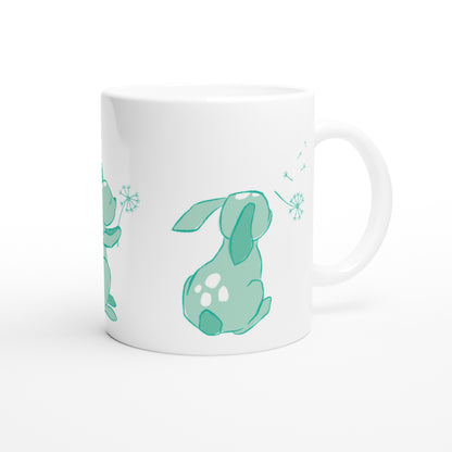White ceramic mug with a mint green Dandelion and hare print.