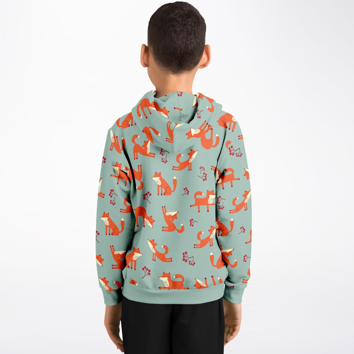 A boy wearing a lichen green hoodie with playful fox pattern.