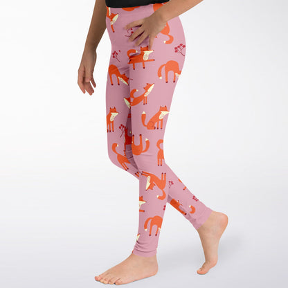 A girl wearing pink leggings with Playful Fox pattern, closeup.