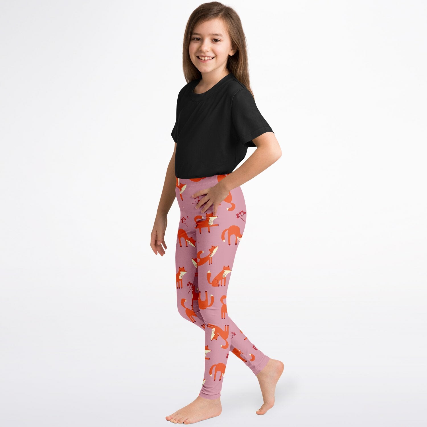 A girl wearing pink leggings with Playful Fox pattern.